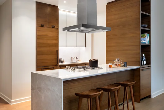 Custom kitchen cabinetry with matte black hardware, Turkish marble countertop and backsplash designed by Andre Kikoski Architect.
