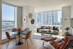 Floor-to-ceiling windows provide maximum natural light and showcase sweeping water and city views
