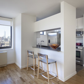 The gourmet kitchen at One Union Square South features Euro-style cabinetry and granite countertops.
