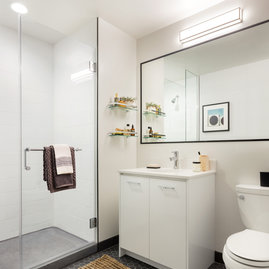Classically tiled bathrooms feature oversized medicine cabinets. 