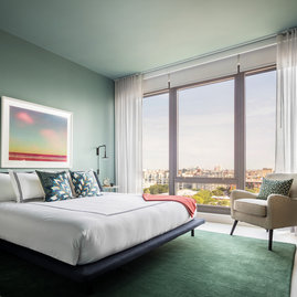 Spacious bedrooms include floor-to-ceiling windows.