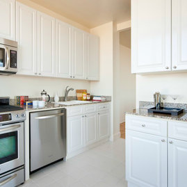 Some layouts feature gourmet kitchens with paneled white cabinet doors, stainless steel appliances and granite counters.