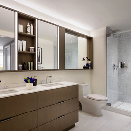 Custom bathrooms include imported Bianco Dolomite polished marble with marble mosaic feature walls