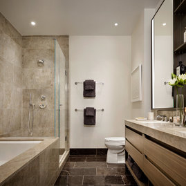 Master bathrooms feature Brazilian quartzite vanities and walls, St. Laurent marble floors and custom cabinetry.