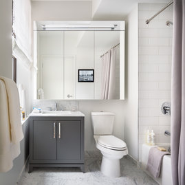 The Arlington's luxurious baths feature Italian marble floors, custom wood cabinetry, and oversized custom-designed medicine cabinets.