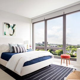 Spacious bedrooms include floor-to-ceiling windows.