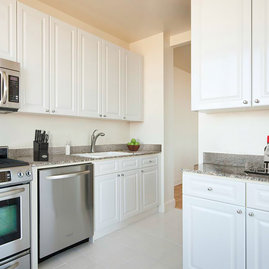 Layouts feature gourmet kitchens with paneled white cabinet doors, stainless steel appliances and granite counters.
