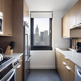Tribeca Tower features gourmet kitchens with full-sized stainless steel appliances, custom wood cabinetry and white stone countertops. 