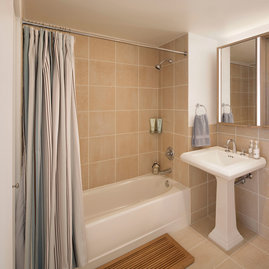 The lavish baths at The Paramount feature a pedestal sink and Italian tile walls and floors.