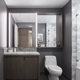 Luxe bathrooms include grey-oak vanities with marble counters and custom medicine cabinets.