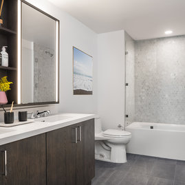 Inspired baths include a marble tub surround and glass enclosed shower, custom double vanity and medicine cabinet.