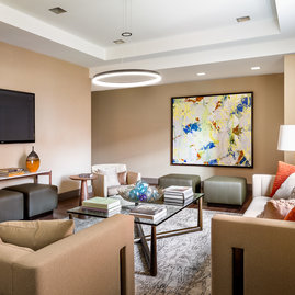 Relax and socialize with friends in an intimate club setting with a large screen TV, open kitchen and lots of comfy chairs.