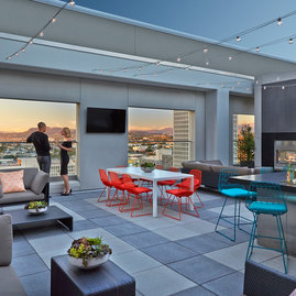 Rooftop terrace with dining tables and BBQ grills.