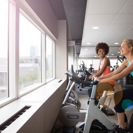 Private on-site fitness center includes ample natural light.