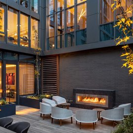 Landscaped courtyard with lounge area and fireplace