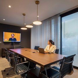 The resident-only co-working lounge includes individual workstations, private offices, and conferencing spaces.