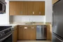 Superb kitchen finishes include quartzite stone countertops, bamboo cabinetry and stainless steel appliances.