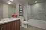 The lavish baths in The Emerson's apartments feature a marble counter and tub surround, walnut vanity with a Toto undermount sink, chrome fixtures and a mirrored medicine cabinet for additional storage.