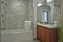 The lavish baths in The Emerson's apartments feature a marble counter and tub surround, walnut vanity with a Toto undermount sink, chrome fixtures and a mirrored medicine cabinet for additional storage.