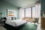 Spacious bedrooms include floor-to-ceiling windows.