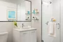 Classically tiled bathrooms feature oversized medicine cabinets.