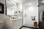 Classically tiled bathrooms feature oversized medicine cabinets. 