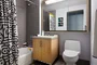 Luxurious tiled baths feature custom wood cabinetry and oversized custom-designed medicine cabinets.