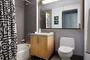 Luxurious tiled baths feature custom wood cabinetry and oversized custom-designed medicine cabinets.