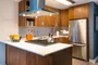 Gourmet kitchens include walnut cabinetry, Caesarstone countertops, and stainless steel KitchenAid® appliances.