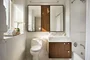 Custom walnut bathroom cabinetry with polished nickel hardware and imported Thassos polished marble countertop and floors, oversized marble showers and double vanities.