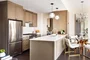 Top-of-the-line appliance suite featuring stainless steel refrigerator, gas range with oven, microwave in custom millwork pantry and integrated dishwasher.