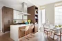 Custom kitchen cabinetry with matte black hardware, Turkish marble countertop and backsplash designed by Andre Kikoski Architect.