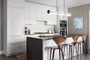 Kitchens feature Subzero built-in refrigerator, bottom mount freezer, Bosch Benchmark appliances including electric oven, gas cooktop, integrated dishwasher and microwave drawer.