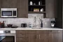 Gourmet kitchens feature gas cooktops and Bosch appliances with quartz counters and a marble backsplash.