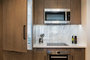 Kitchens feature Quartz countertops and Calcutta marble backsplashes.