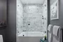 Luxe bathrooms include marble tub surround.