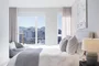 Spacious bedrooms feature blackout shades and a customizable Elfa closet-shelving system.