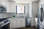 The gourmet kitchen at One Union Square South features Euro-style cabinetry and granite countertops.