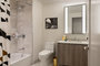 Well-appointed master bathrooms feature vanities with Italian white marble, grey marble walls, and medicine cabinets with integrated lighting and pulls.