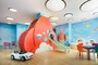 Children's playroom stocked with toys, books, and games.