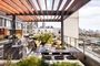 Expansive, lushly landscaped sundeck and lounge area with pool, hot tub and outdoor kitchens.