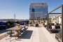 The lushly landscaped sun terrace is furnished with lounge chairs and shaded cabanas.