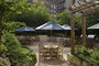 The meticulously landscaped garden patio includes outdoor dining space with barbeques for residents.