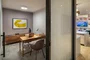 The resident-only co-working lounge includes individual workstations, private offices, and conferencing spaces.