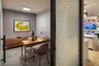 The resident-only co-working lounge includes individual workstations, private offices, and conferencing spaces.