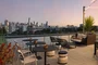 Rooftop Terrace with barbecue grills, fire pits and outdoor TVs set against views of the city skyline