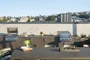 Rooftop Terrace with barbecue grills, fire pits and outdoor TVs set against views of the city skyline