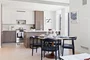 Open kitchen with custom cabinetry, premium stainless steel, gas appliances and flexible dining space