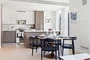 Open kitchen with custom cabinetry, premium stainless steel, gas appliances and flexible dining space