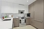 Open kitchen with custom cabinetry, premium stainless steel, gas appliances and flexible dining space